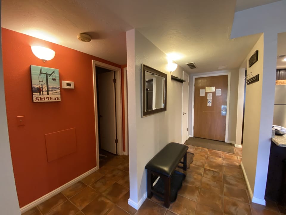 Entry Hallway with ski rack, coat hooks, boot trays, bench and mirror.