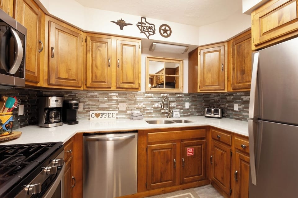 Your home away from home features a fully stocked kitchen with modern appliances and charming Texas touches, making meal prep feel effortless.