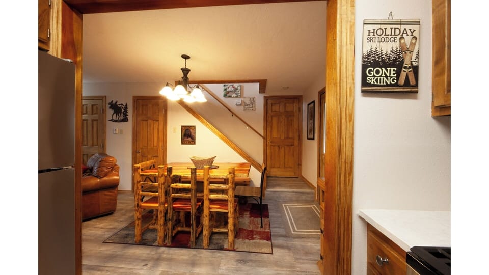 Step into your cozy mountain retreat with warm wood accents and rustic charm. The open layout invites you to gather around the dining table after a day on the slopes.