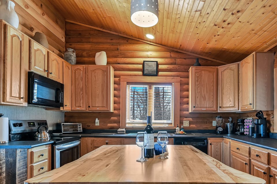 Kitchen window looks out onto deck with hot tub