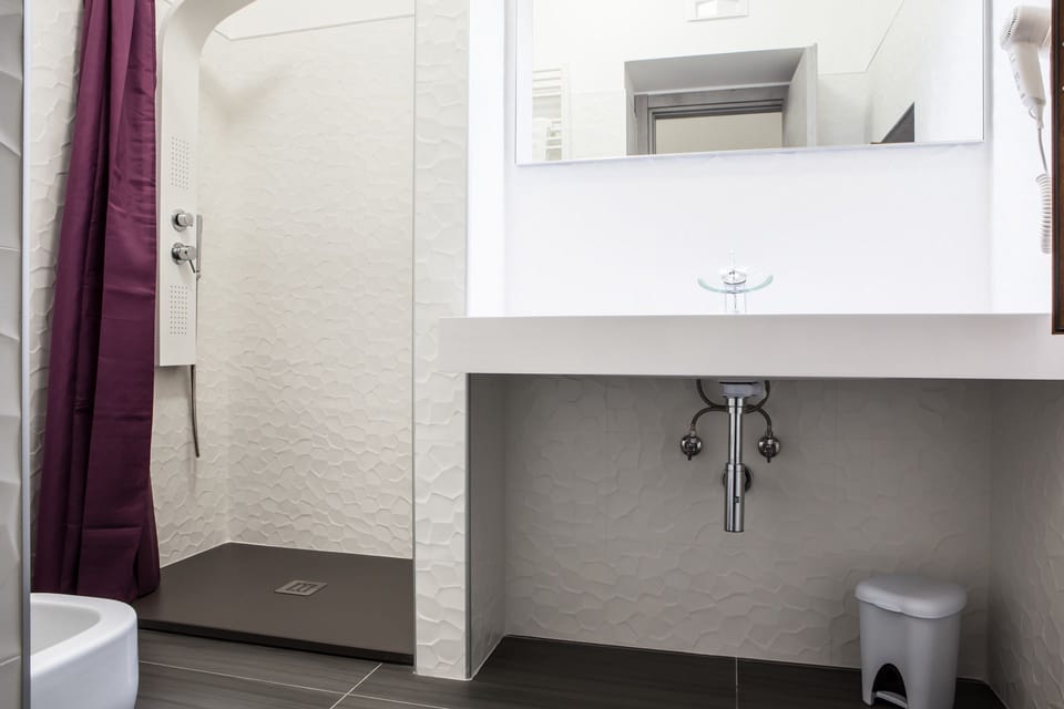 Bathrobes, slippers, bidet, towels