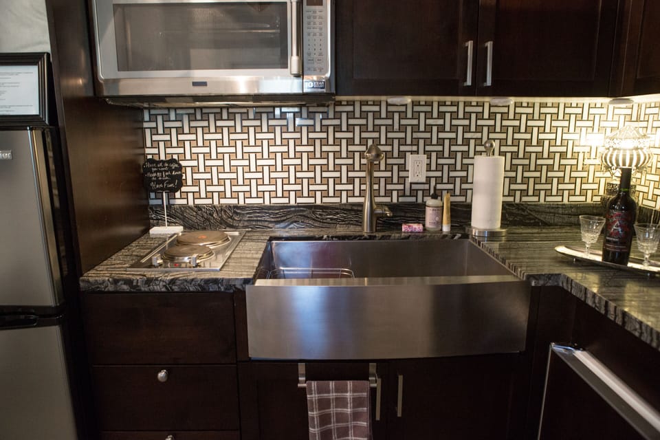 Deep farmhouse kitchen sink. 2 burner cooktop. Convection Oven/Microwave combo.