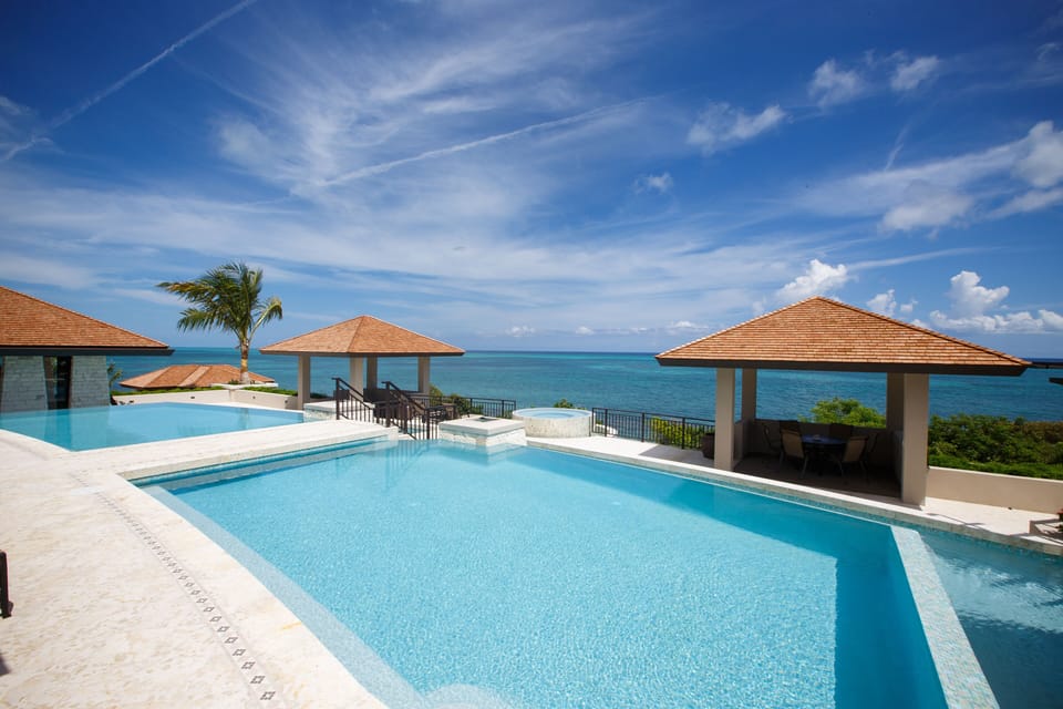 Chaise lined, dramatic infinity-edge resort sized pool.
