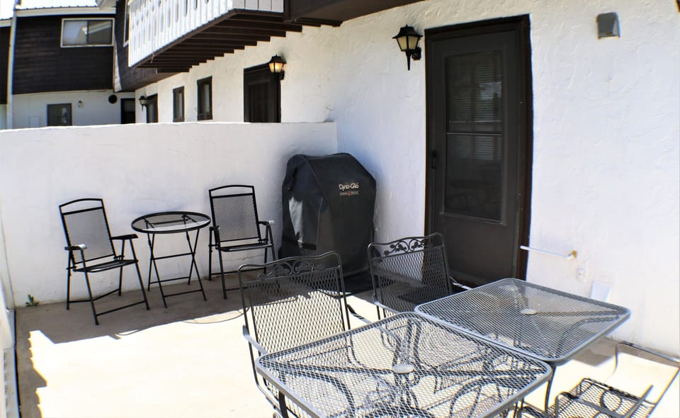 Relax on your private patio with multiple seating areas and a BBQ grill, perfect for morning coffee or evening meals under the open sky.