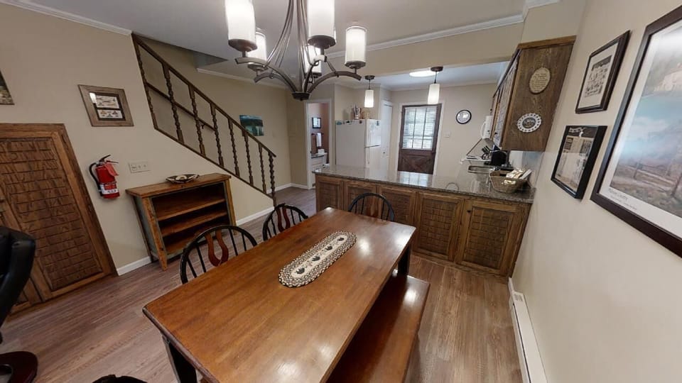 Step into your welcoming dining and kitchen space, where warm wood finishes and thoughtful details invite you to share memorable meals together around the cozy table.