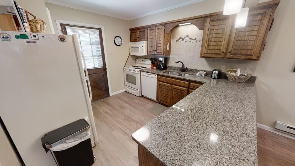 Your fully equipped kitchen features granite countertops, charming wood cabinetry, and all the appliances you need to prepare delicious meals during your stay.