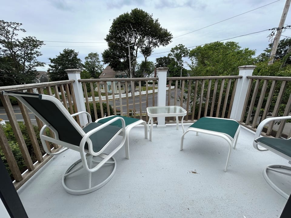 Deck overlooking Cross Street with comfortable seating on each side