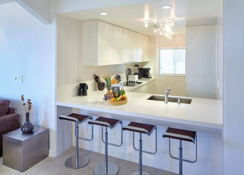 Kitchen is optimized for socializing and utility and enjoys ocean views