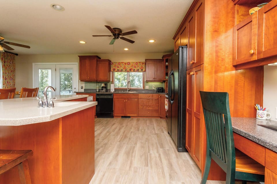 Large well stocked kitchen with center island and seating for 2.