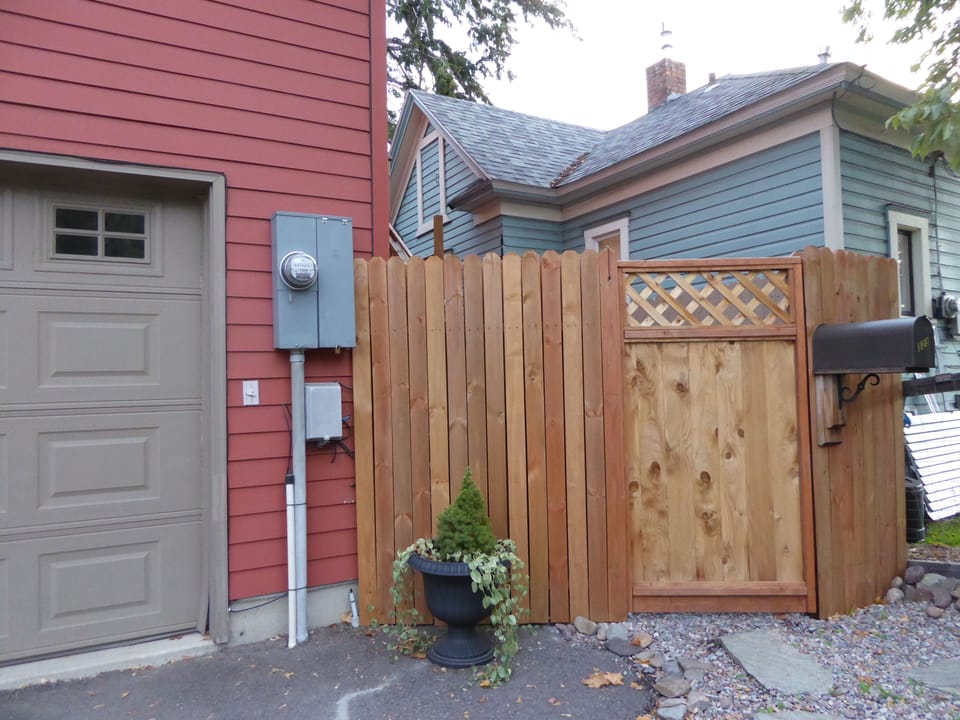 Gate to stairs.  Light switch for stairs is to left of electrical box.