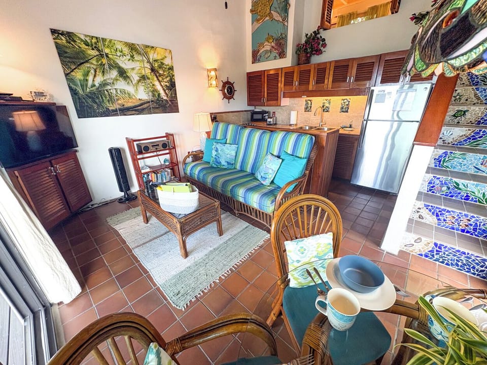 Looking from the dining area to the kitchen and living room.  The stairs take you to the bedroom and bathroom level