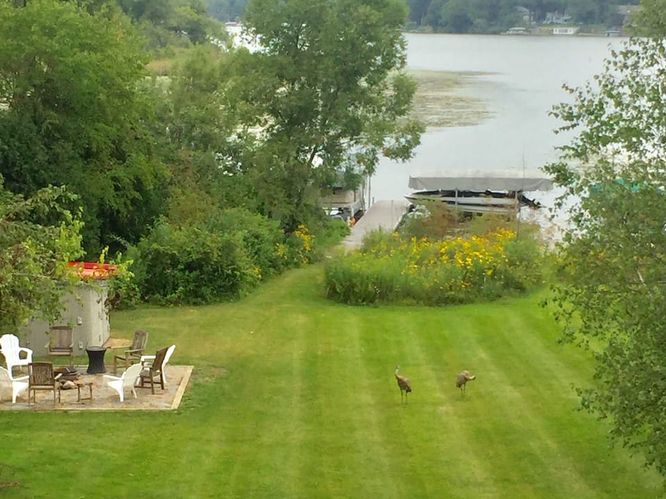 View of fire pit, pier and lake from lower deck