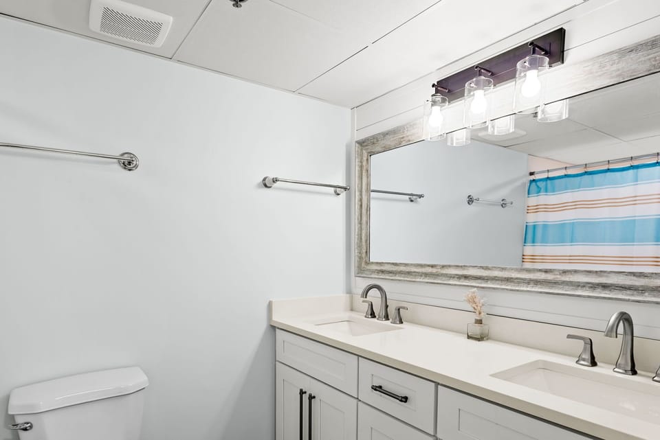 Guest room #1 with tub/shower combination, dual sinks, new cabinetry and fixture
