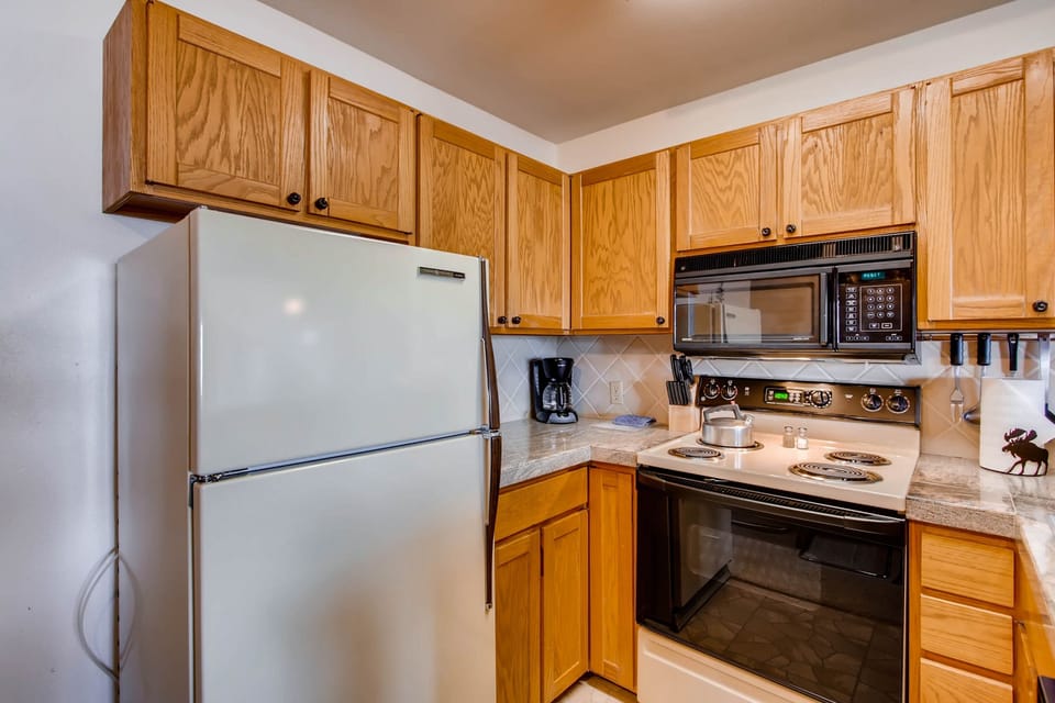 Condo, 2 Bedrooms | Private kitchen | Coffee/tea maker, oven, cookware/dishes/utensils