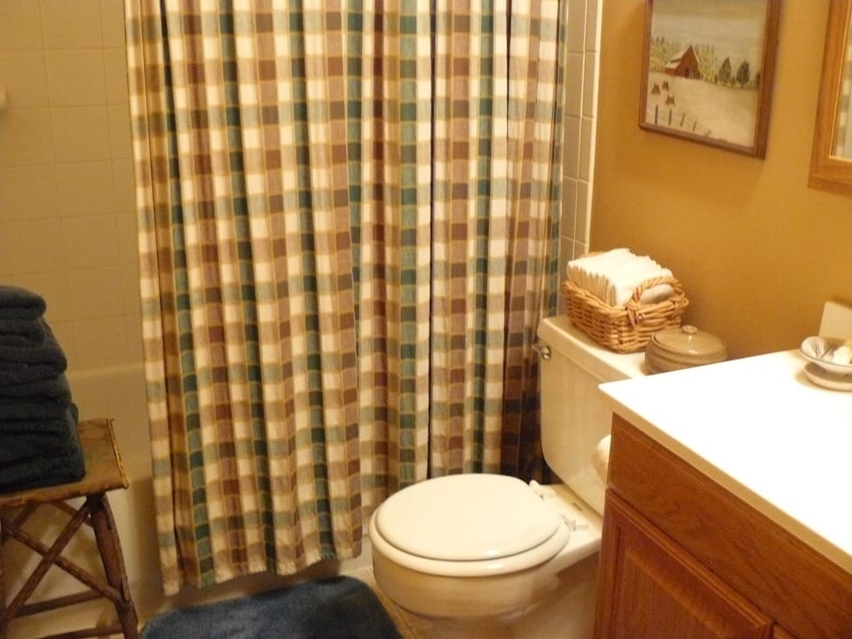 Upstairs bath has shower/tub combo and plenty of storage.
