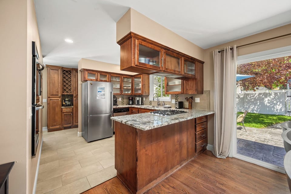 Prepare your favorite meals in this fully equipped kitchen with warm wood cabinetry, granite countertops, and modern appliances—with plenty of counter space for cooking together.
