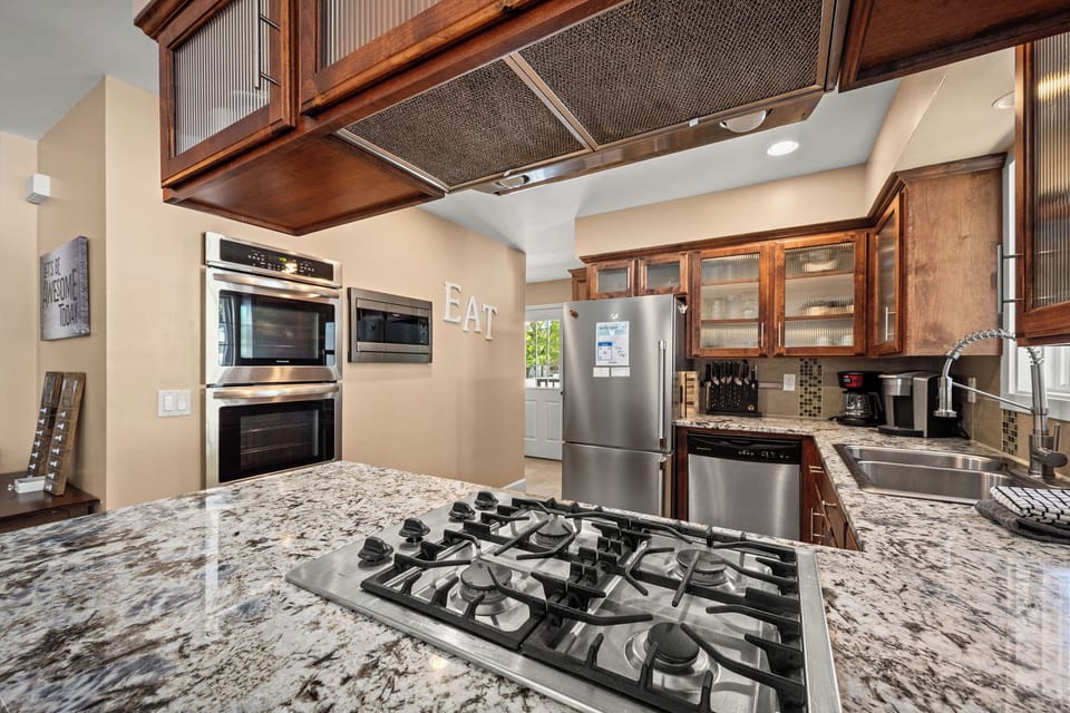 Your chef's kitchen awaits with granite countertops, a gas range, built-in oven, and plenty of prep space to create delicious meals during your stay.