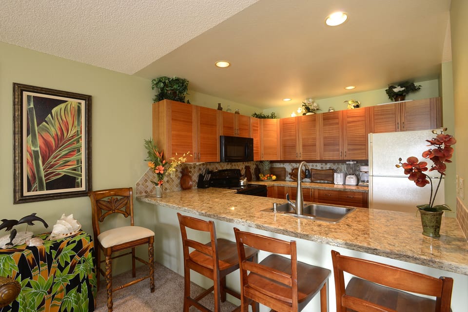 Remodeled kitchen has mahogany cabinets, quartz countertops & new dishwasher.