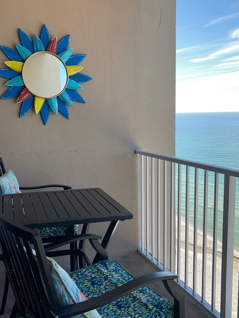 Balcony includes 4 chairs with cushions and 2 tables