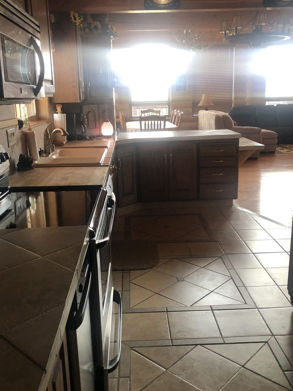 Kitchen view with kitchen bar in the background and dining area behind