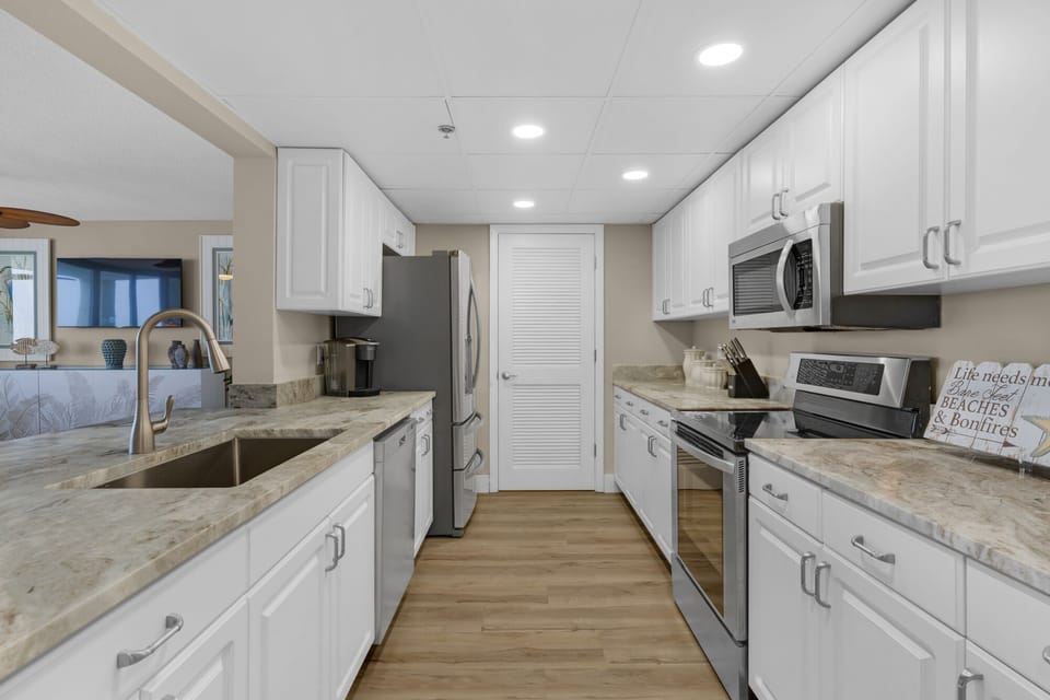 Full sized washer and dryer behind louvered door area