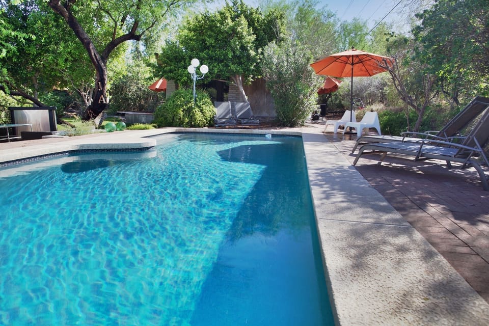 The swimming pool and loungers are directly in front of the guesthouse