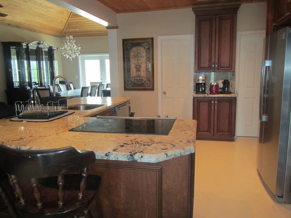 Gourmet kitchen with stainless steel appliances, coffee bar, granite counter tops and marble floors. Serve your family and friends on an elegant Italian 10 chairs dining room set.