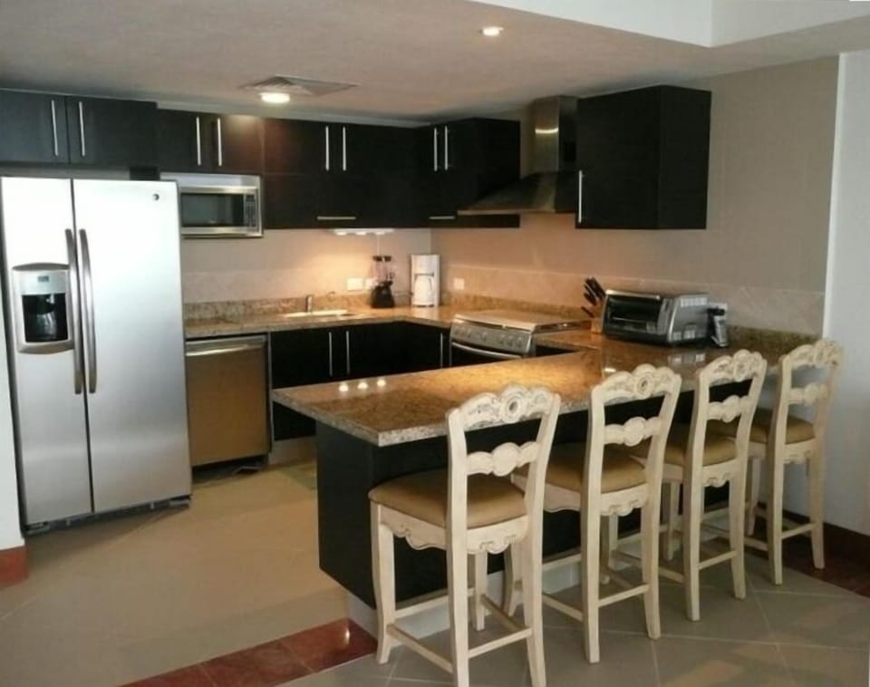 Stainless steel appliances in fully-outfitted kitchen