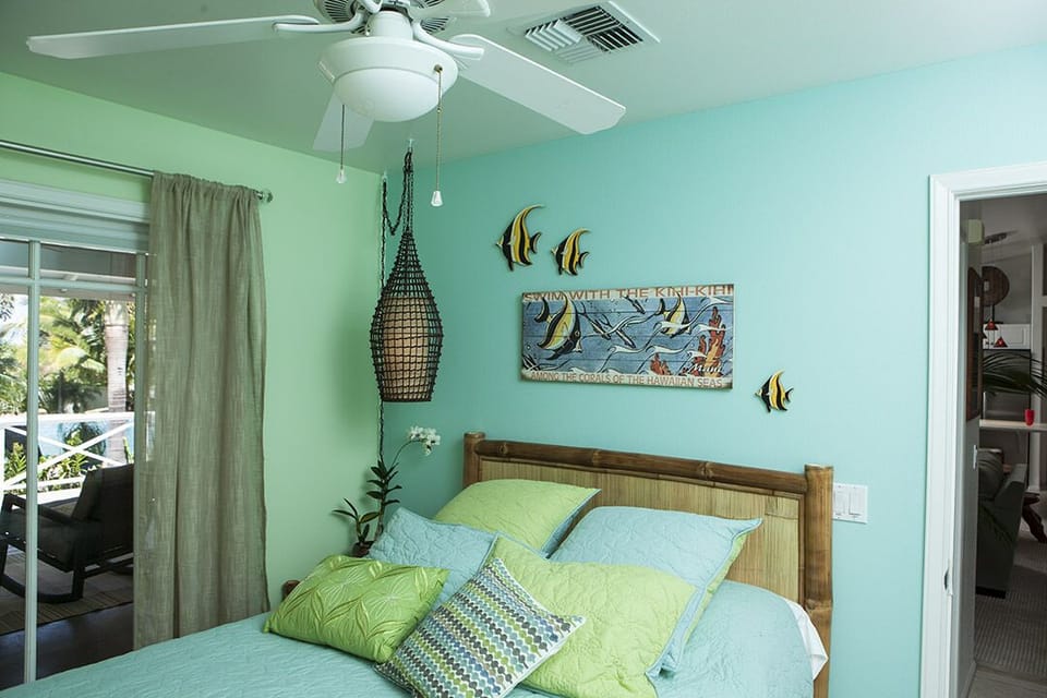 Smaller guest bedroom with queen size bed, french doors open to Oasis yard.