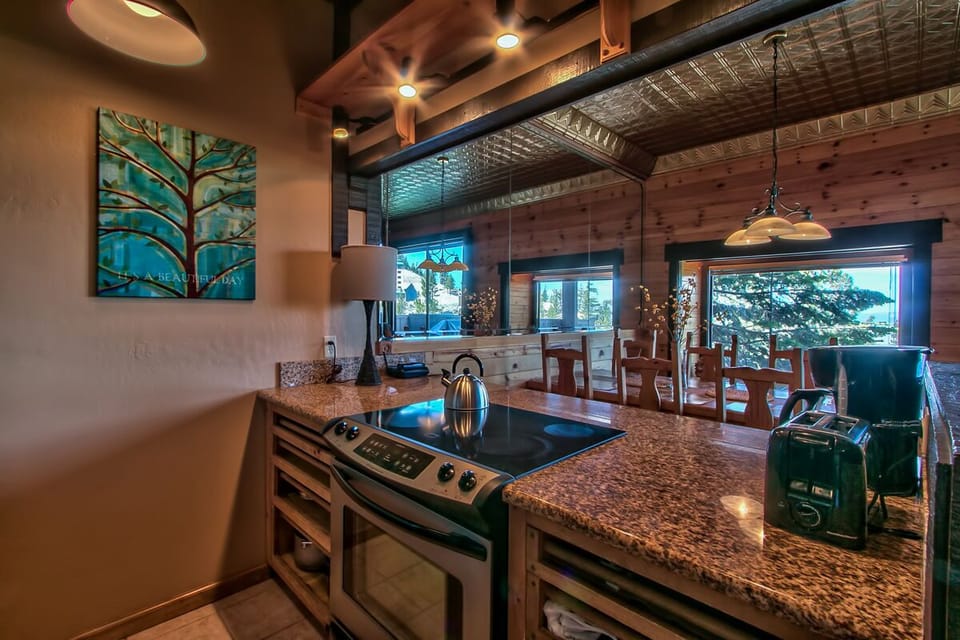 fully equipped kitchen opens to living room and dining.