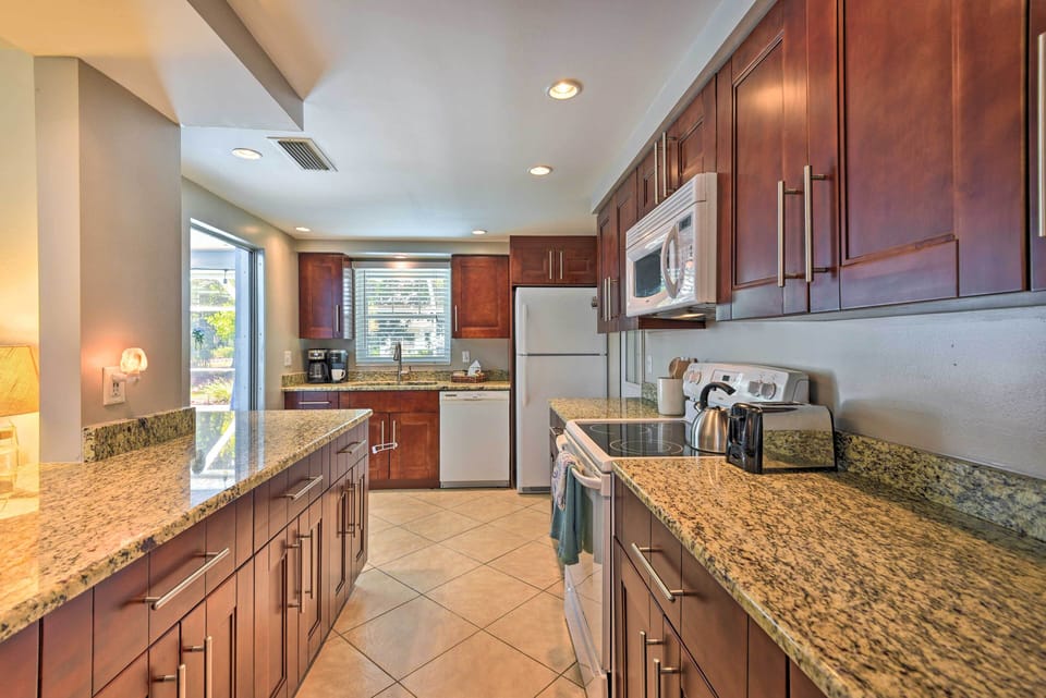 The over-size kitchen comes fully stocked and gives access to the lanai.