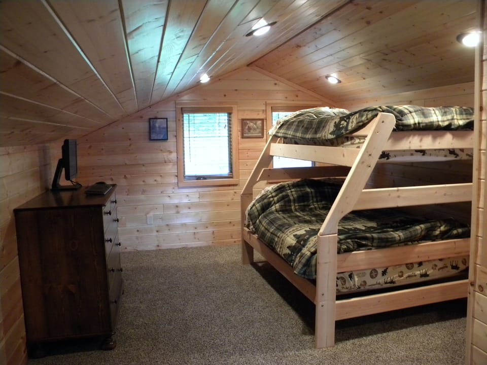 Upper loft bunk bed with full and twin on top.