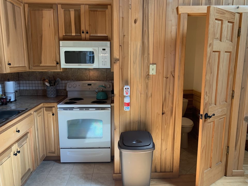 Convenient half bathroom located in the kitchen/living room area.