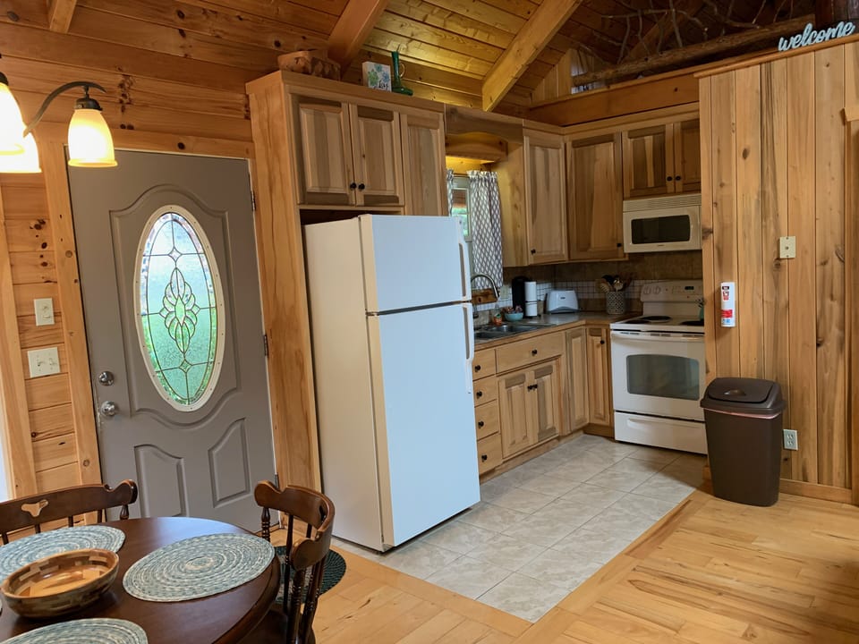 Large refrigerator, stove with oven, and microwave.