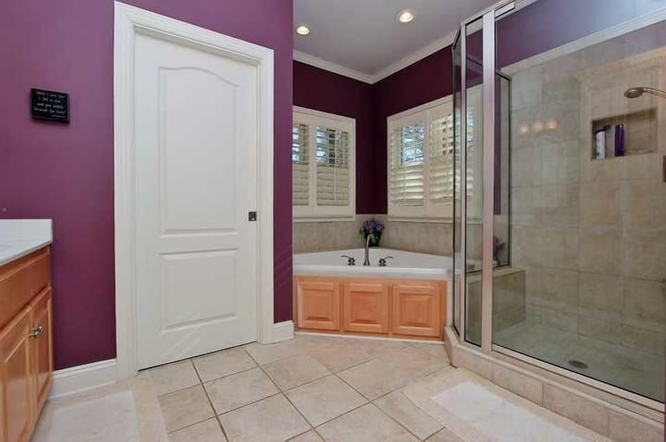 Master bathroom with glass shower and jetted tub