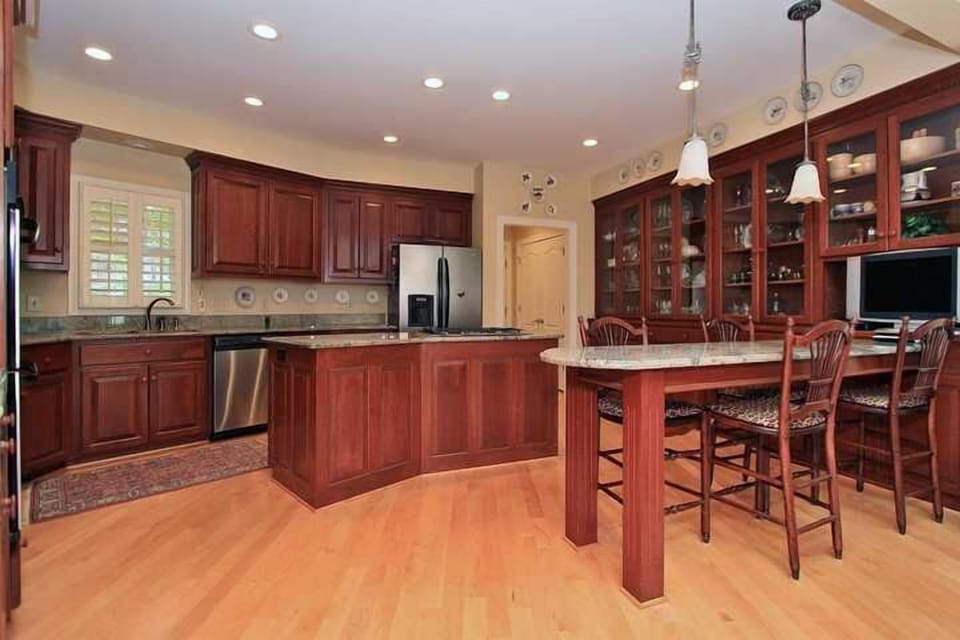 Custom gourmet kitchen with cherry cabinets, granite countertops, and stainless