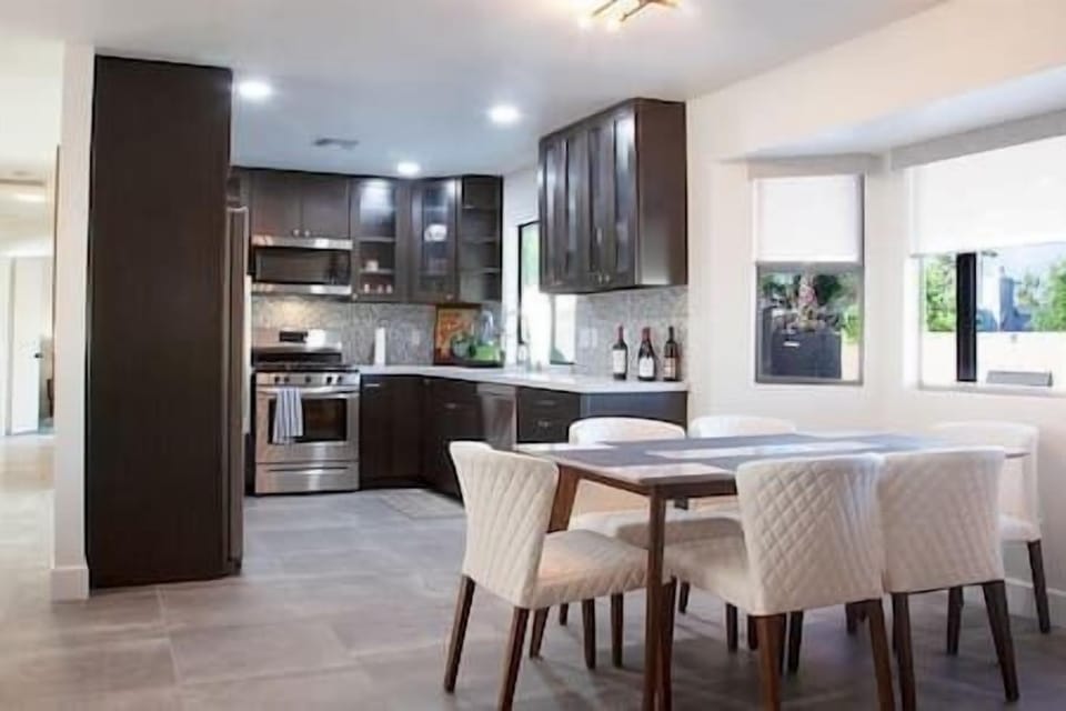 Gather in this bright and airy dining and kitchen area, where natural light and thoughtful design create the perfect setting for meals and memories. Enjoy a warm, inviting space for cooking, dining, and connection.