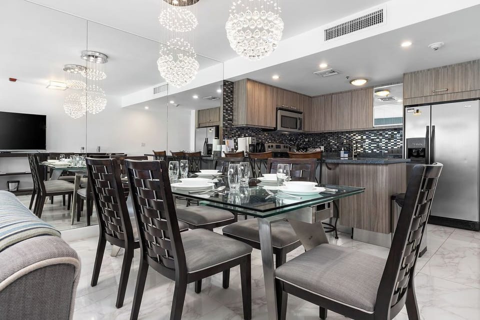 Gather around your elegant dining space, where glittering chandeliers set the mood for memorable meals. The modern kitchen stands ready with sleek appliances and stylish finishes, perfect for cooking up your vacation favorites.