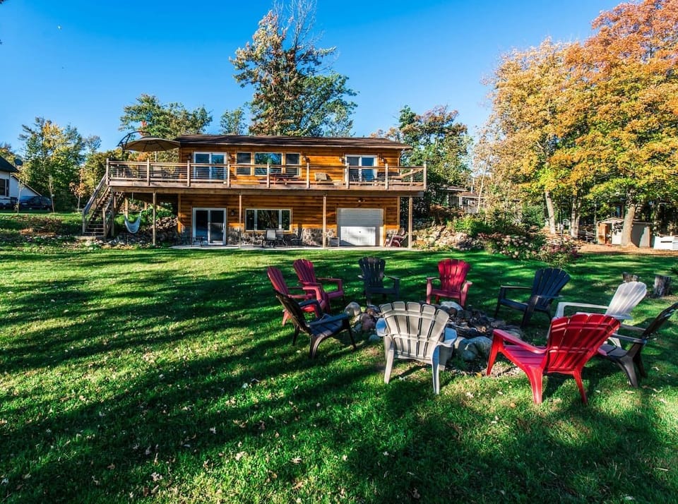 Large wrap-around deck overlooking the lake — perfect for morning coffee, sunset dinners, and relaxed lake days.