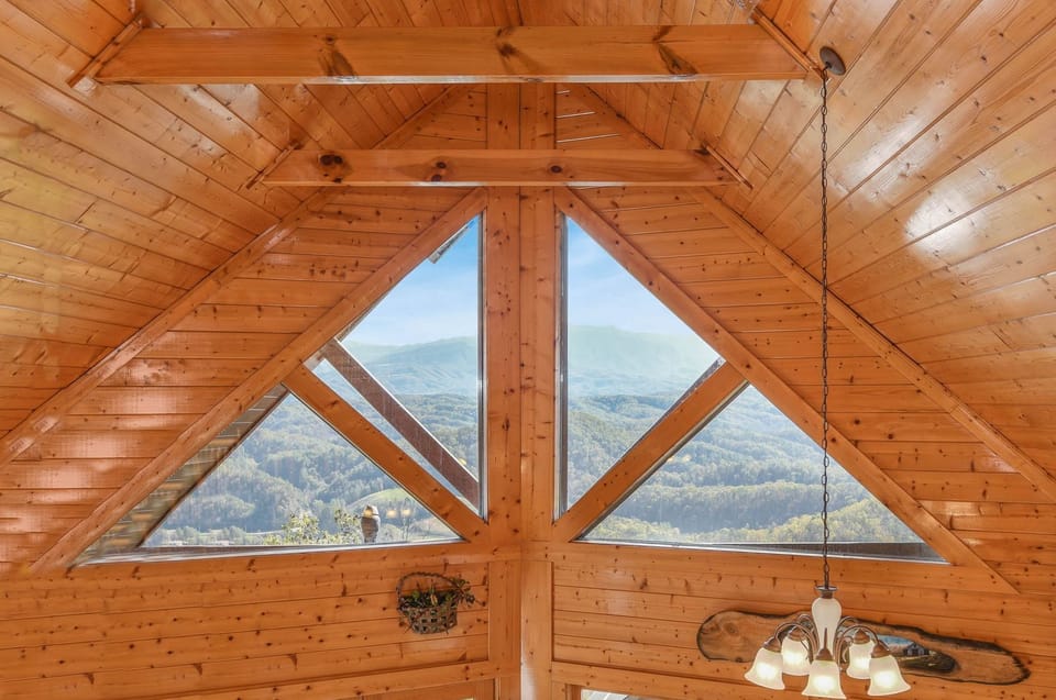 - Lofted A-frame ceiling with grand triangular windows framing the Smokies   - Natural light floods the space with breathtaking views and rustic elegance   - A stunning architectural highlight of this cozy mountain retreat