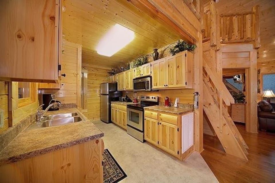 - Fully equipped kitchen with stainless appliances and rustic wooden cabinetry   - Prepare family-style meals surrounded by cabin warmth and mountain charm   - A functional and cozy space for cooking and connection in the Smoky Mountains