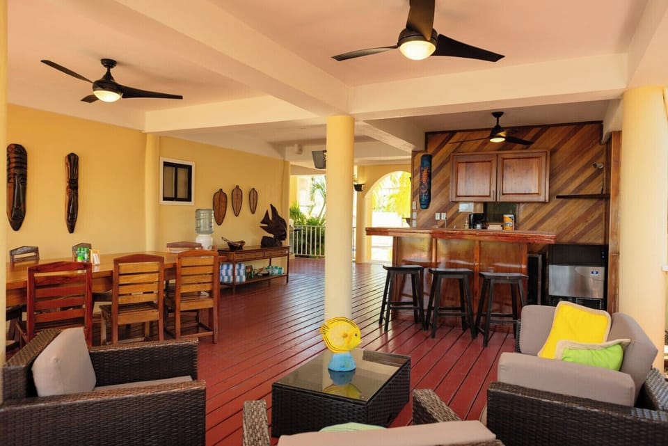 Open-air common Area (ground level): open-air dining table (left), bar (right) lounge (bottom-middle).