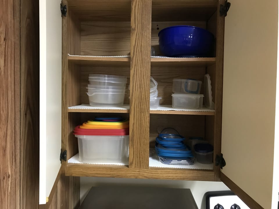 Lots of plastic storage containers in various sizes and multiple mixing bowls