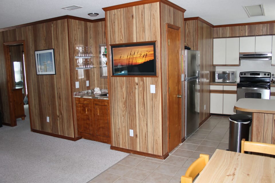 Living Area Wet Bar with wine & cocktail glasses, sink, blender & smoothie maker