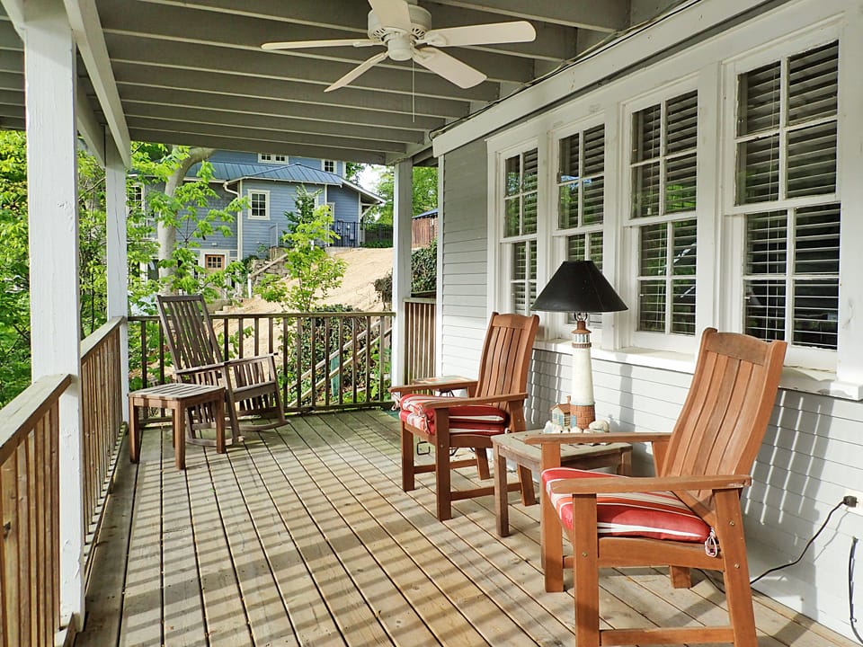 Treehouse Cottage lower-level deck overlooks Saugatuck Harbor and docks