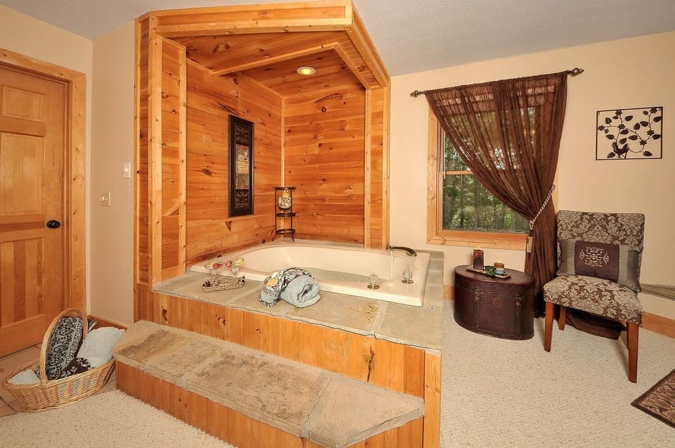 - Wood-paneled jacuzzi corner with window views   - Romantic spot to soak and relax after exploring trails   - Inviting warmth and privacy in this mountain hideaway