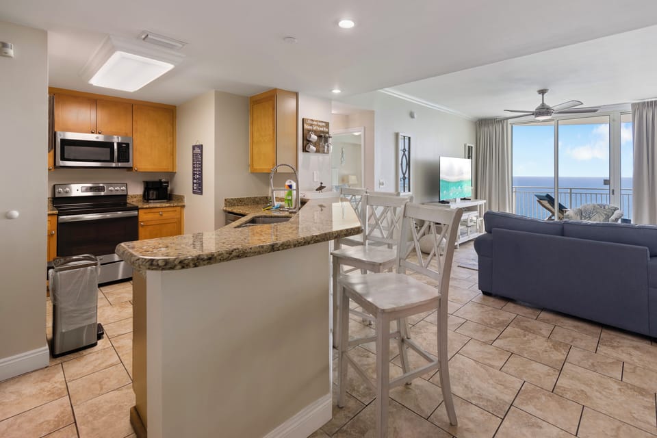 Cook with ocean views from your granite-topped kitchen island, then relax in the spacious living area with stunning sea views.