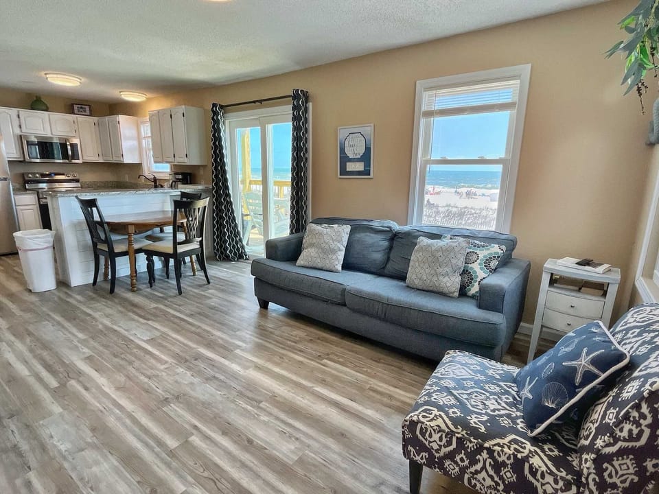 The living / dining area is open with direct access to the private beach front balcony!