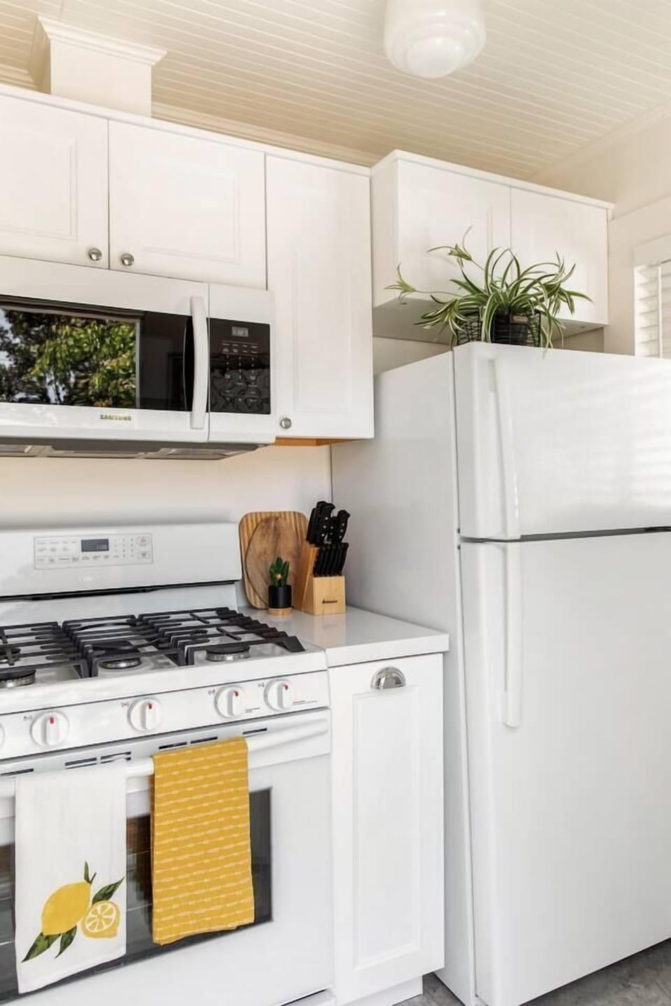 Complete kitchen with full size new appliances, pots, pans and dishes for cooking at home.   