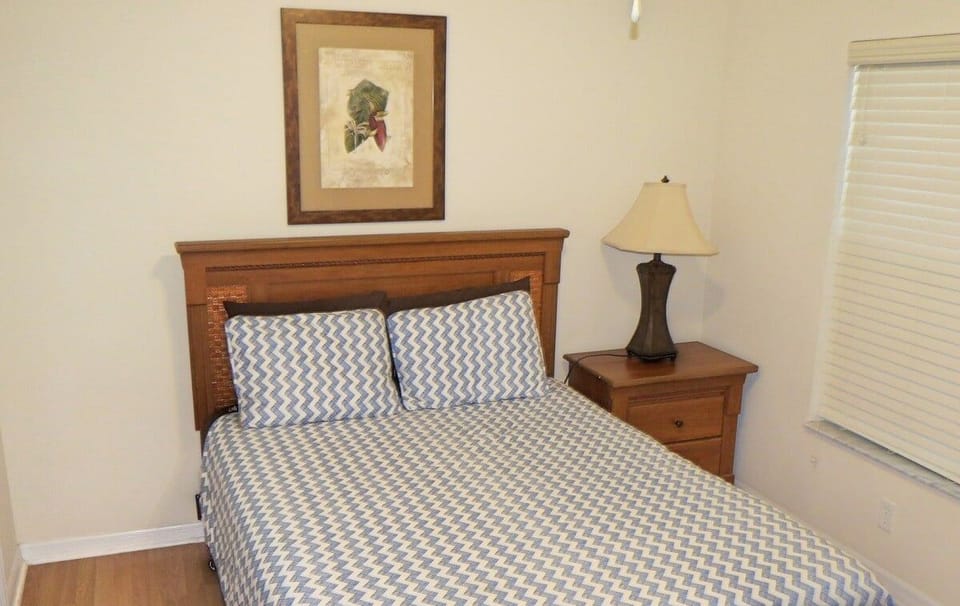 main floor queen with flatscreen and attached bath